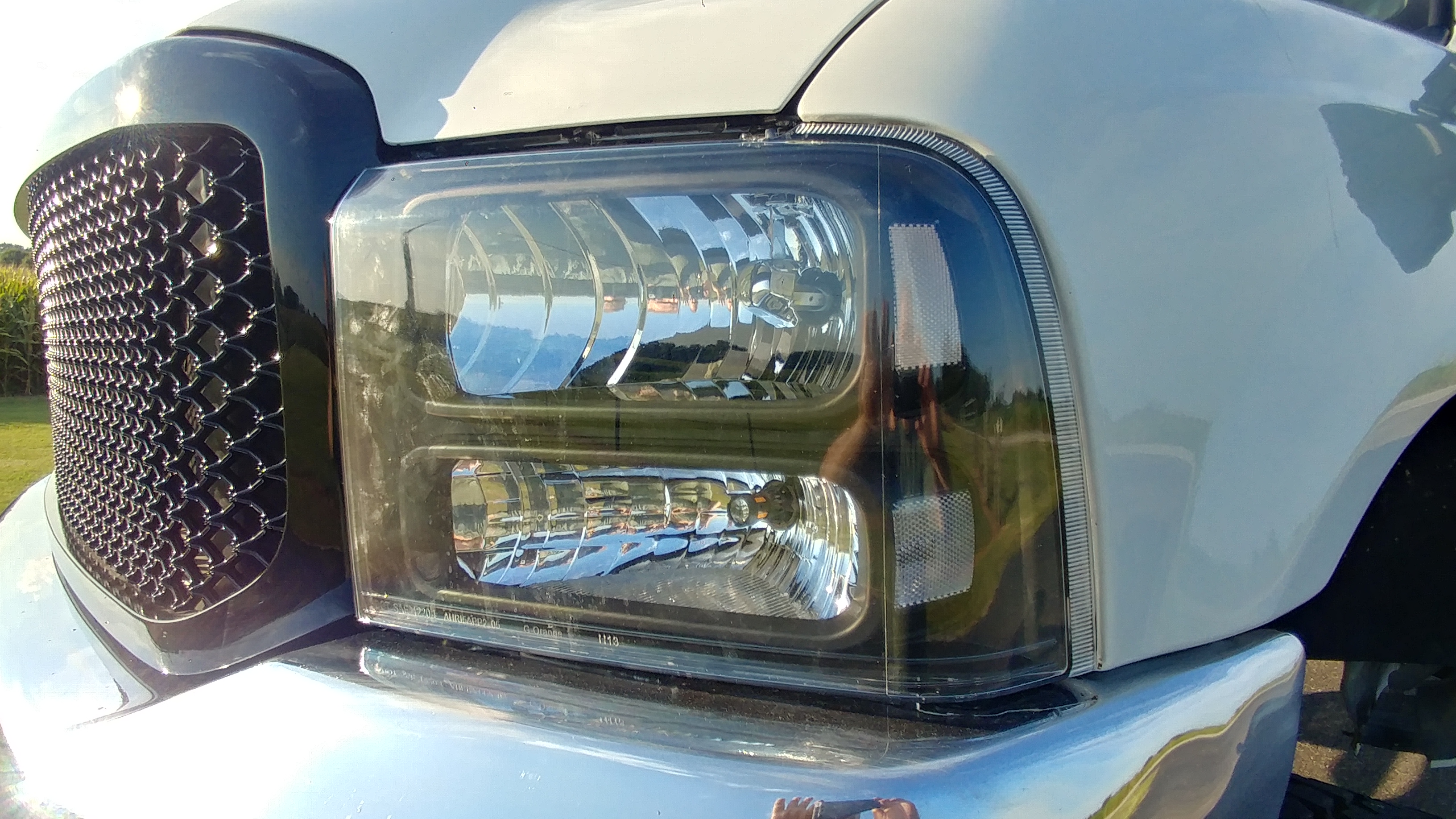 One piece headlight and front grille