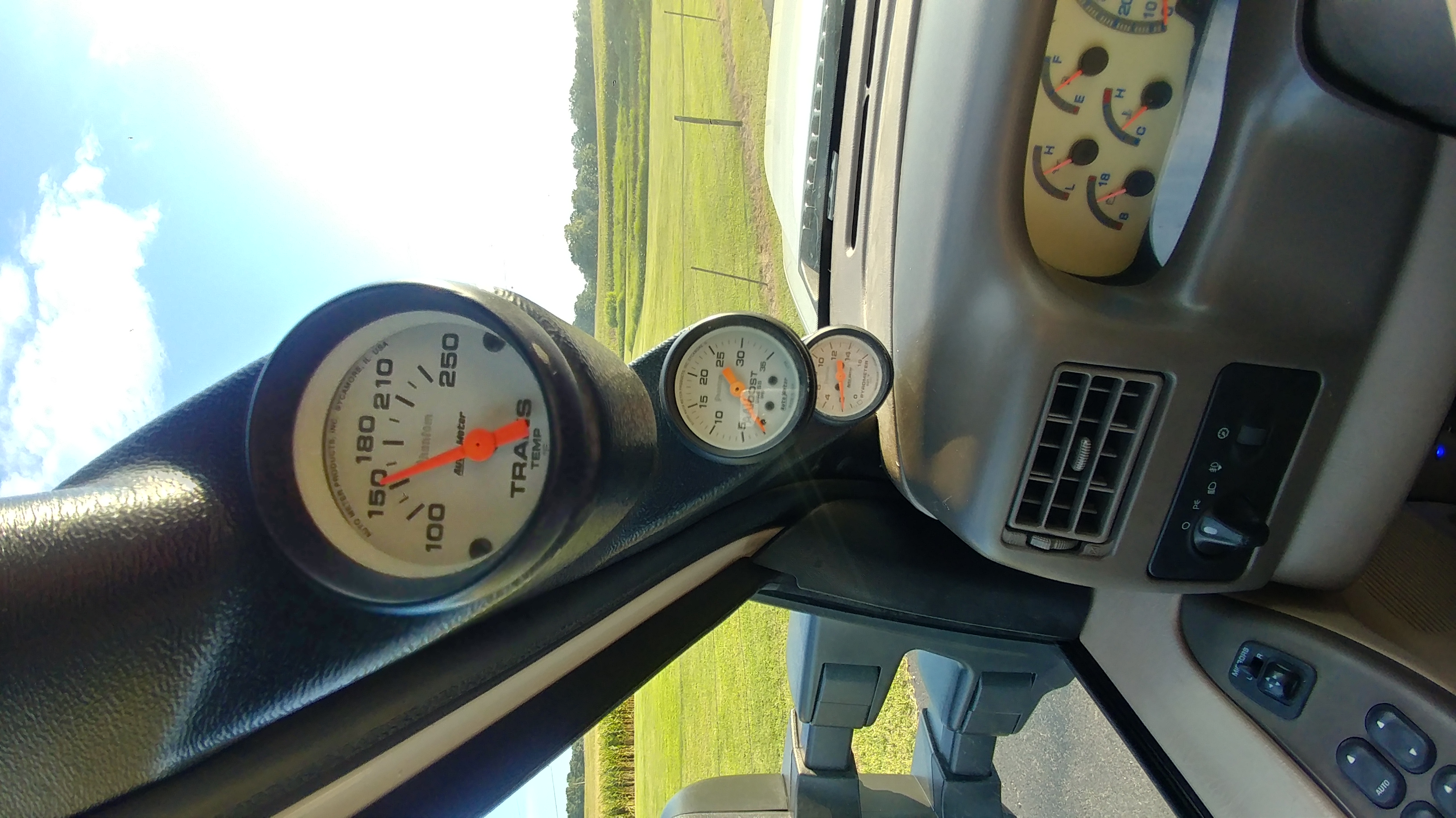 Three AutoMeter pillar gauges: trans temp, boost and pyrometer